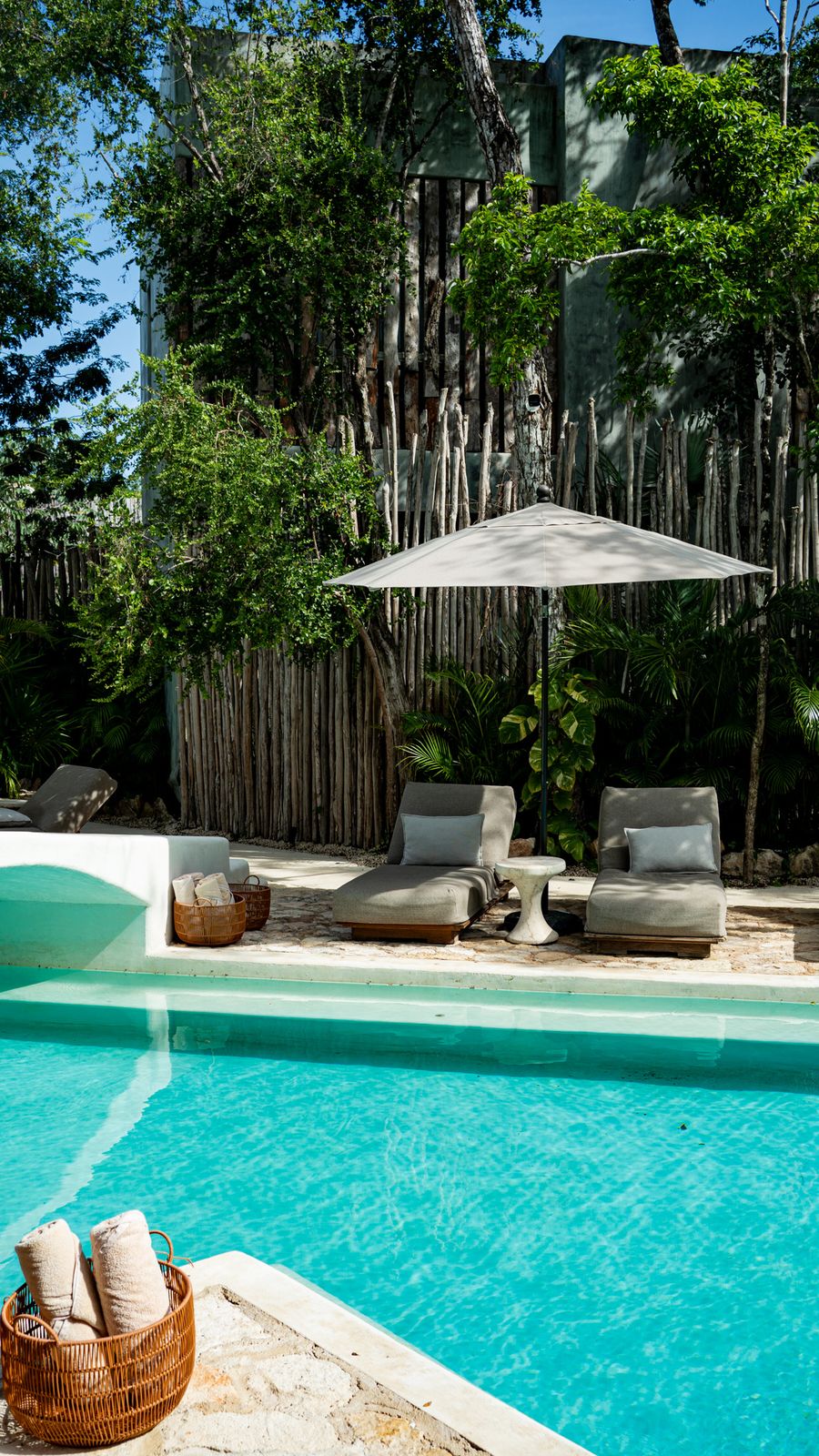 Poolside loungers under an umbrella