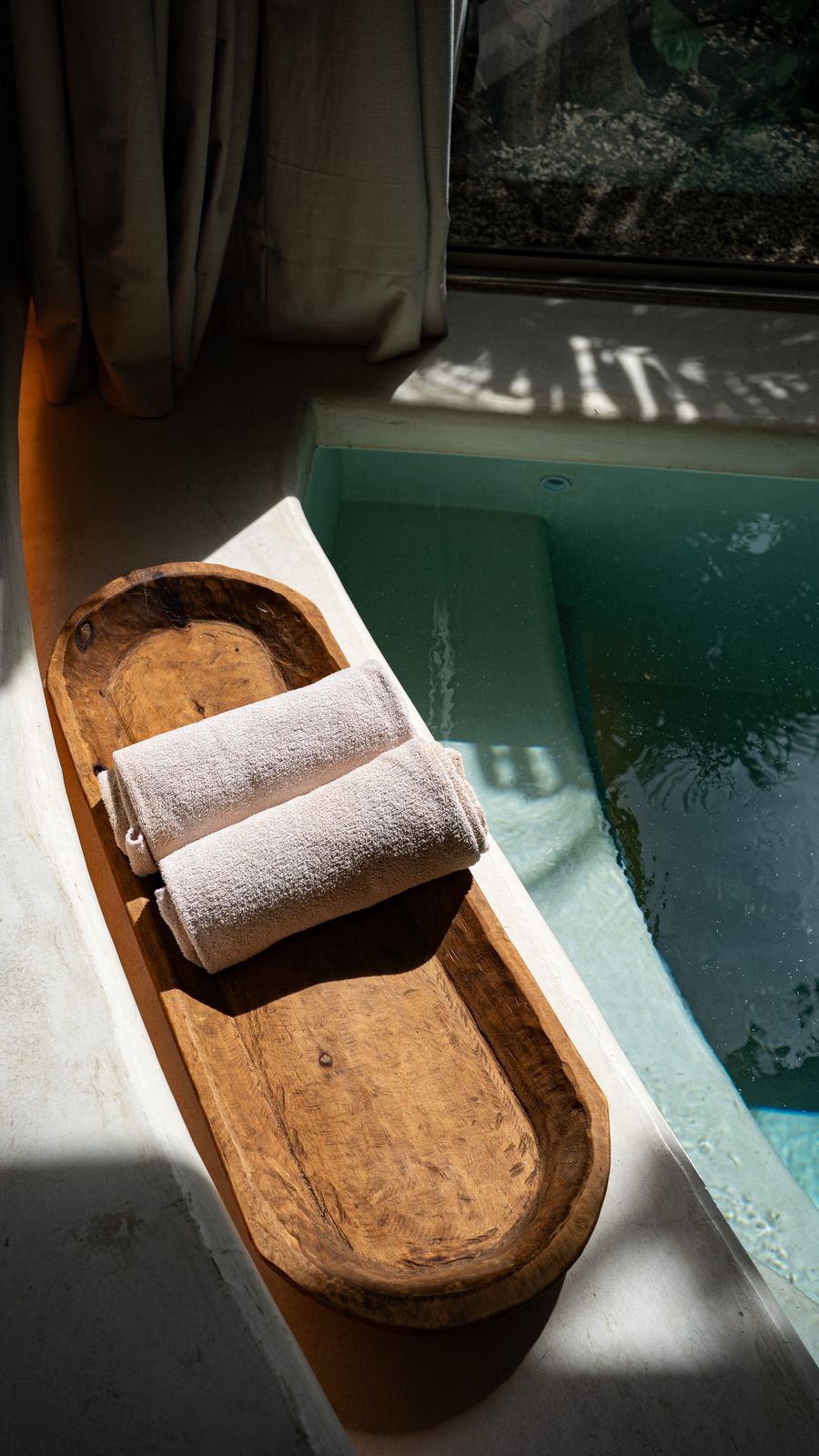 Rolled towels by the plunge pool